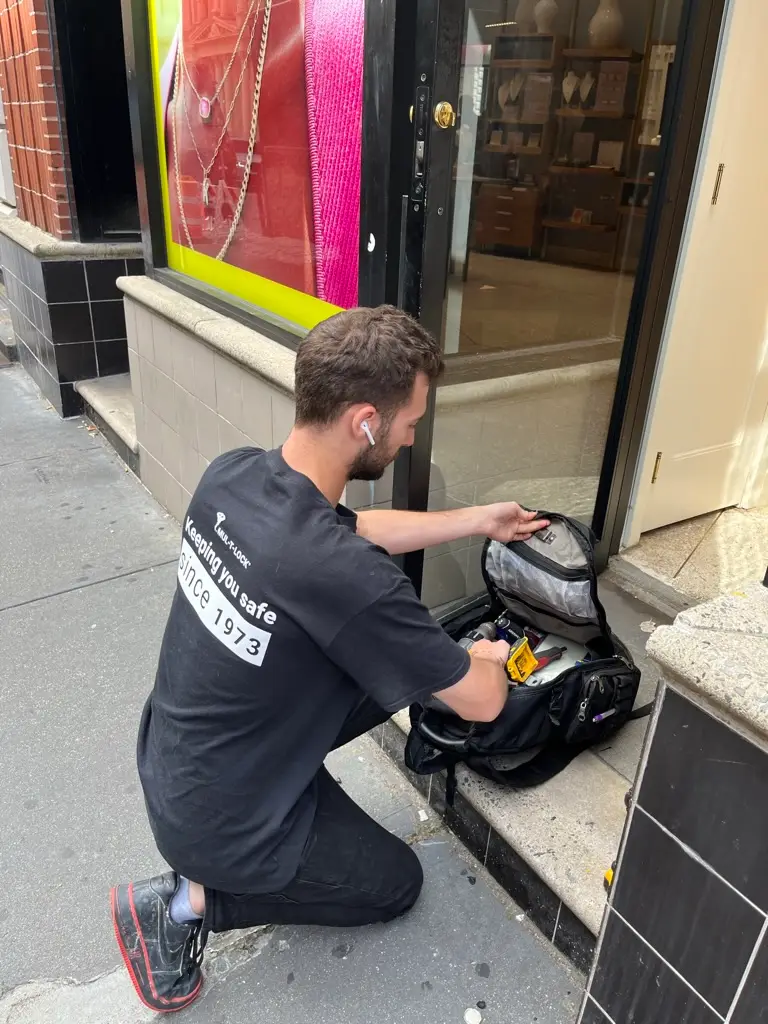 Locksmith opening a locked commercial storefront glass door